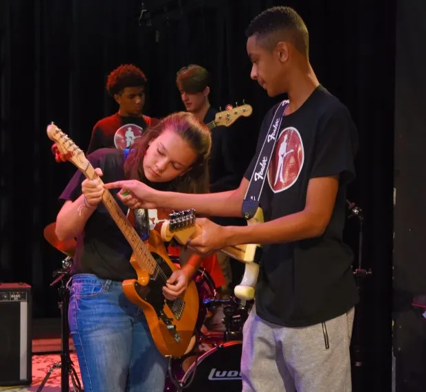 Fernando Jones, right, instructs a guitar player at one of his Blues Kids camps in 2017. Governors State University in University Park will host a three-day blues camp in July. Auditions take place May 29. (Glenn Kaupert)