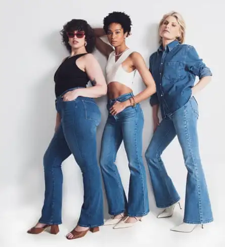 Three women in bootcut or flared jeans