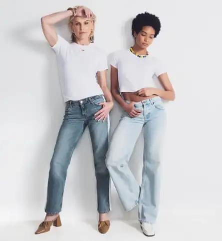 women in white T shirts and low-rise jeans