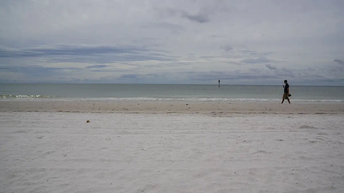 Person walking on sand at Clearwater Beach
