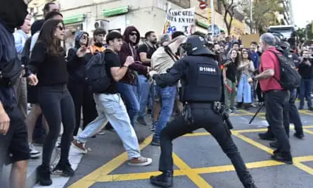 Police and demonstrators clash outside Park Güell.