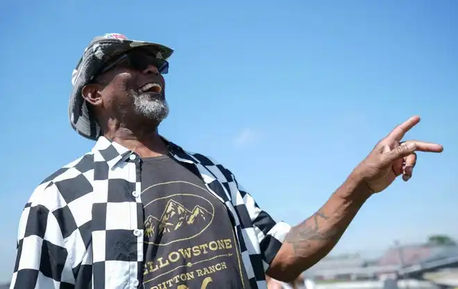 Aaron Hank Jenkins cheers as cars dry by Friday, May 24, 2024, during Carb Day ahead of the 108th running of the Indianapolis 500 at Indianapolis Motor Speedway.