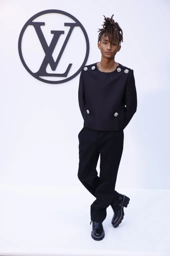 Jaden Smith poses at the photocall of the Louis Vuitton fashion show at Park Guell in Barcelona wearing black leather boots