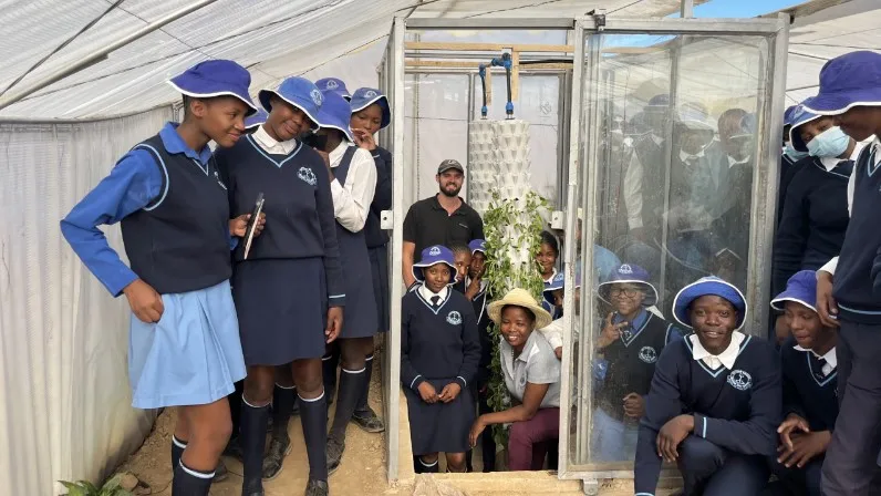 Ivan Ball (center) with fellowship participants at their Lesotho work site. (Photo provided)