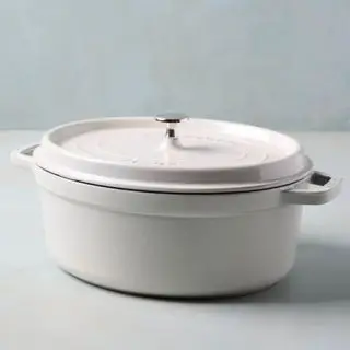 A white Magnolia oval cooking pot on a white backgrouund