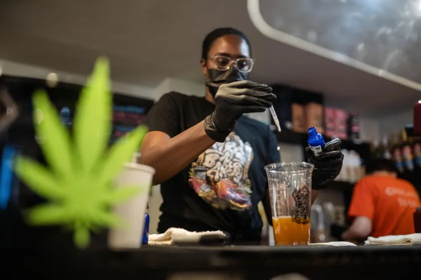 A worker prepares a drink infused with delta-8 THC at Wake-N-Bakery in the Lake View neighborhood.