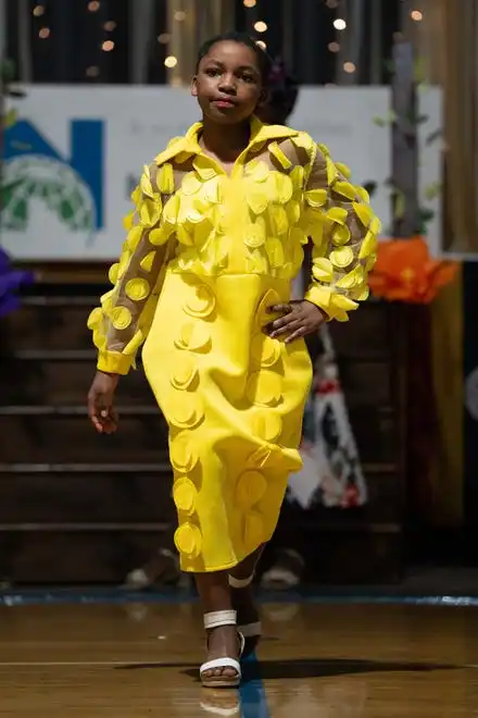 Salima Mwanzawalks down the runway showing off her outfit during the Newcomer Academy Fashion Show on Friday, April 19, 2024.