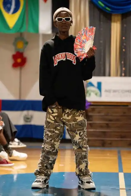 Didier Irakiza shows off his outfit at the Newcomer Academy Fashion Show on Friday, April 19, 2024.