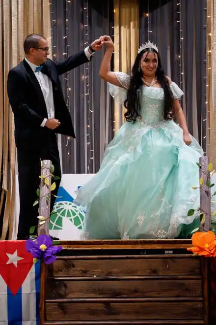 Rafael Benitez shows off Flor Cruz Celso and her dress for her 15th birthday during the Newcomer Fashion Show on Friday, April 19, 2024.