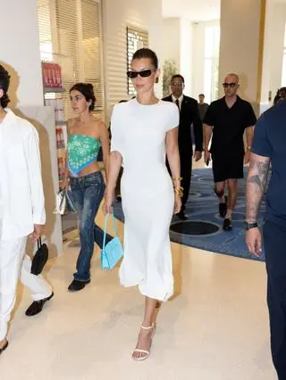 Bella Hadid styles a white dress with bangles.