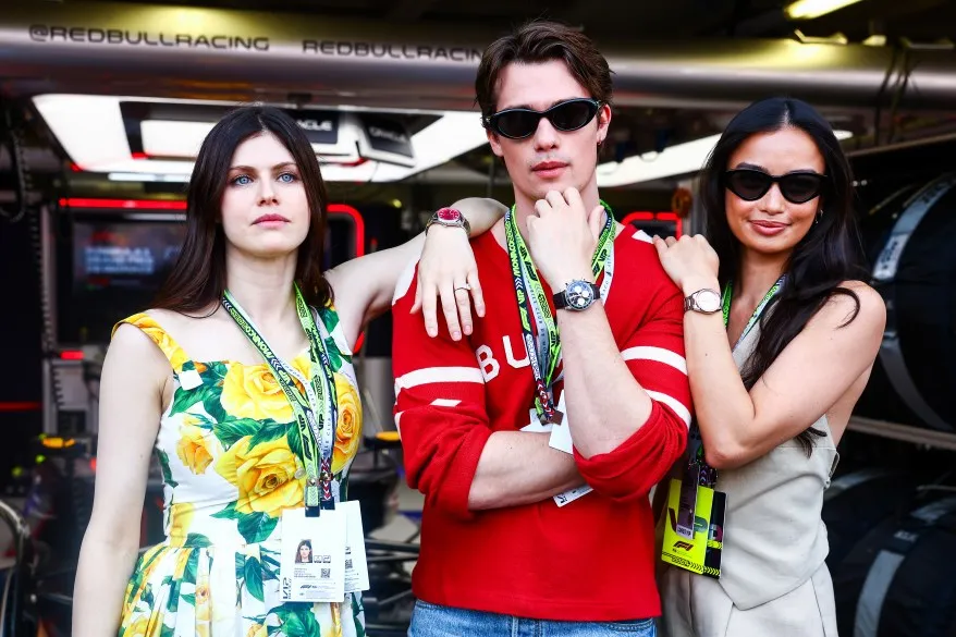 Alexandra Daddario, Nicholas Galitzine and Kelsey Merritt pose for a photo outside the Oracle Red Bull Racing garage prior to the F1 Grand Prix of Monaco at Circuit de Monaco on May 26, 2024