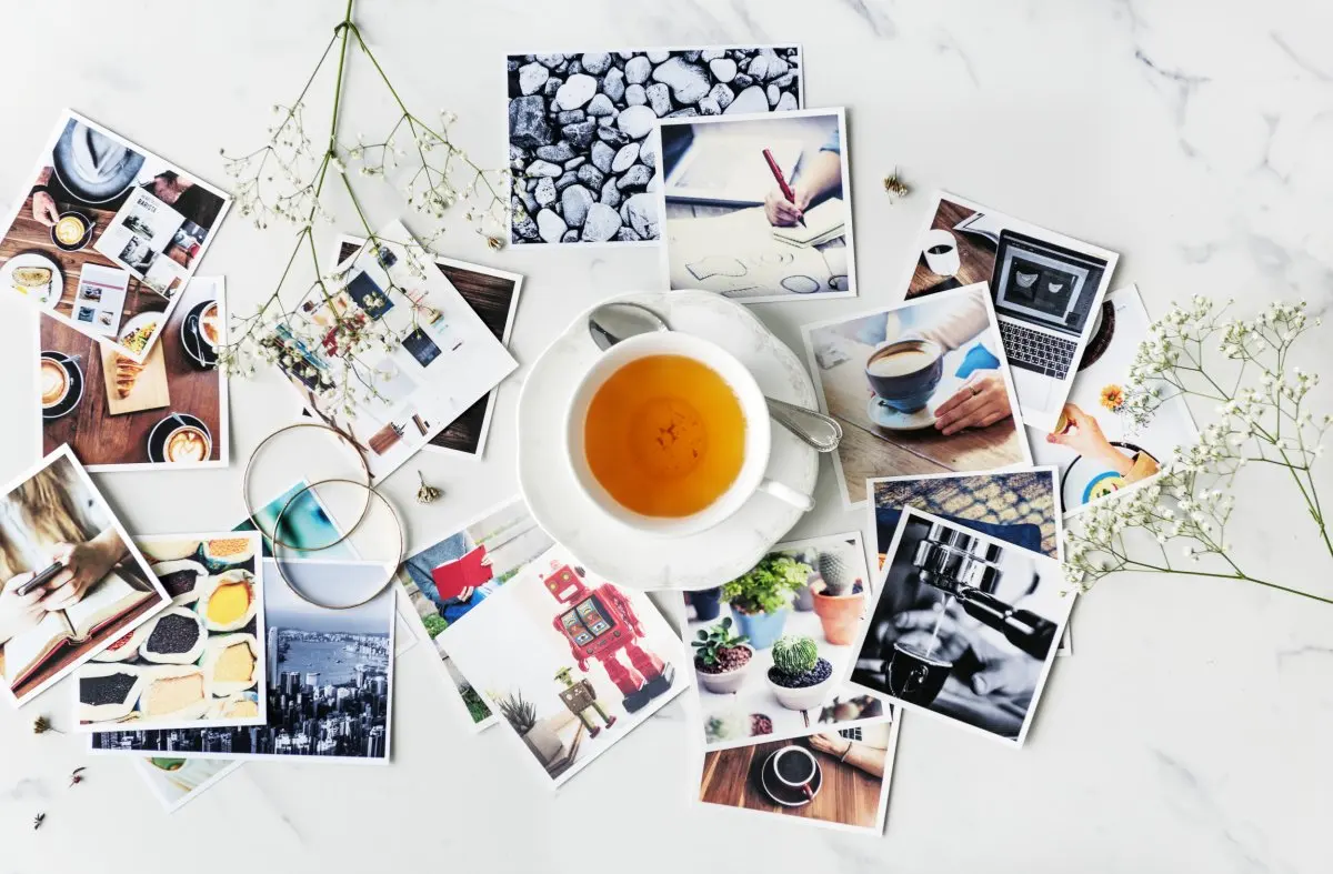 Photographs scattered on a table.