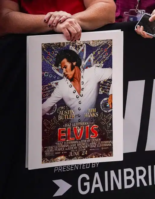 A fan holds a poster featuring actor and honorary starter Austin Butler on the red carpet on Sunday, May 26, 2024, during the 108th running of the Indianapolis 500 at Indianapolis Motor Speedway.