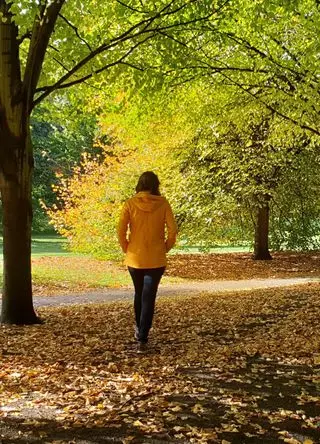 Girl walking in a park in autumn