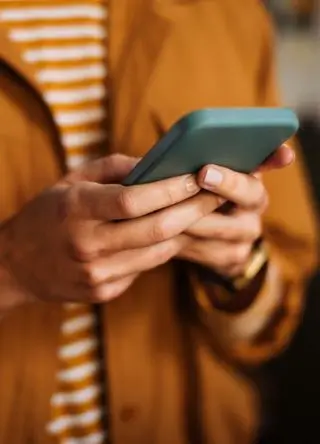 stock photo Shot of an unrecognizable woman using a mobile phone indoors