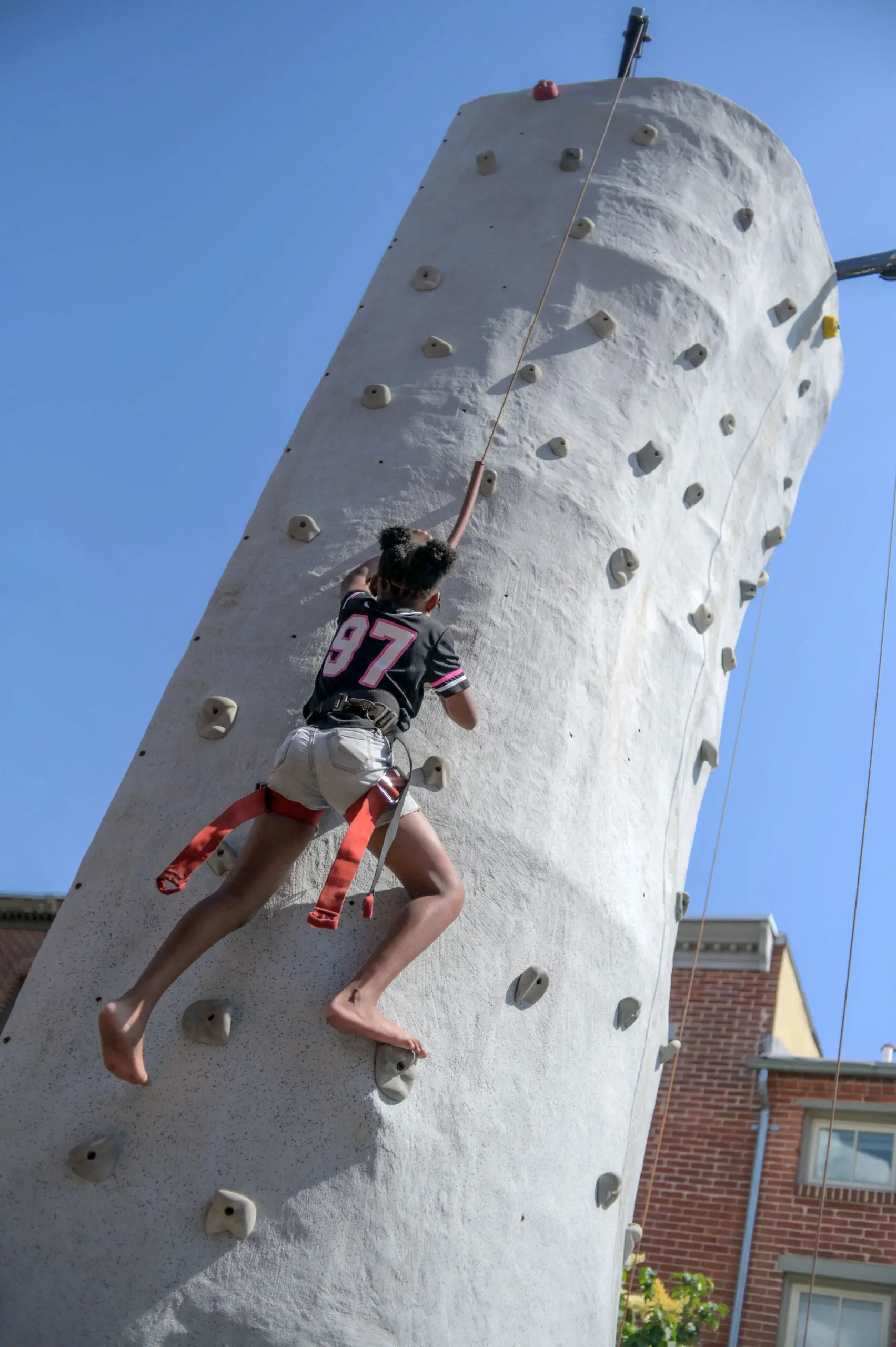 Natalia Smalls, 9 of Hollins Market scales the portable Pigtown Climbs 25-foot climbing wall during the annual Sowebo arts and music festival around Hollins Market. (Karl Merton Ferron/Staff)