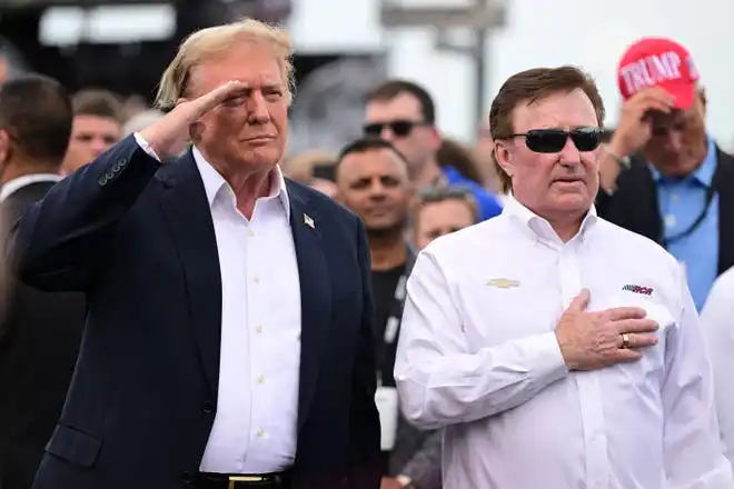 Former President Donald Trump talks with team owner Richard Childress prior to the NASCAR Cup Series Coca-Cola 600.