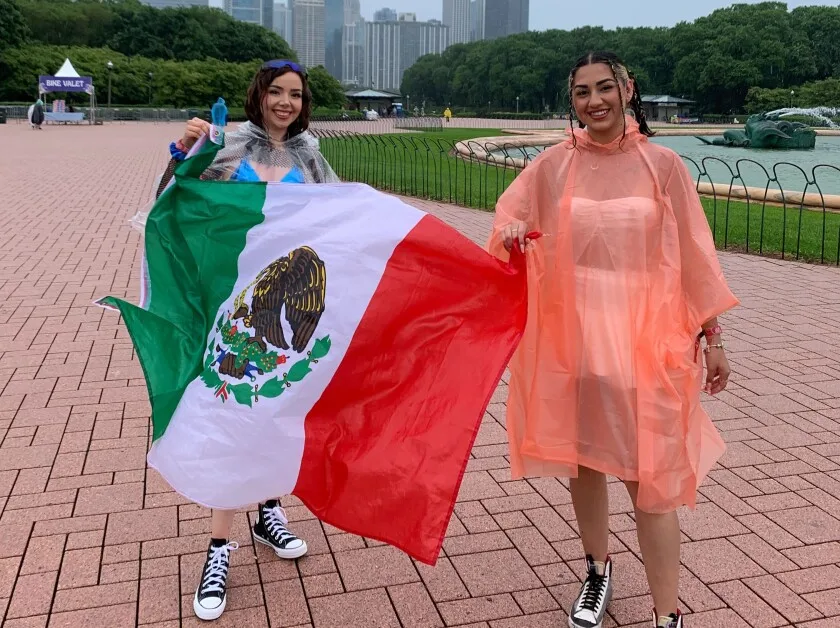 IMG_6380.jpeg. Ashley López, 22 (left) and Lizeth Valle, 21, arrive at Grant Park on Sunday for the Sueños Music Festival, despite rainy weather that prompted a delay to the start of Day 2 of the festival in Grant Park. 