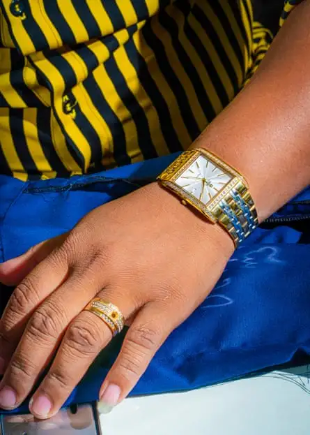 Closeup of a gold watch on a person's wrist