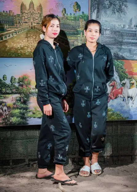 Two women in matching branded boilersuits