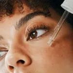 woman applying retinol serum