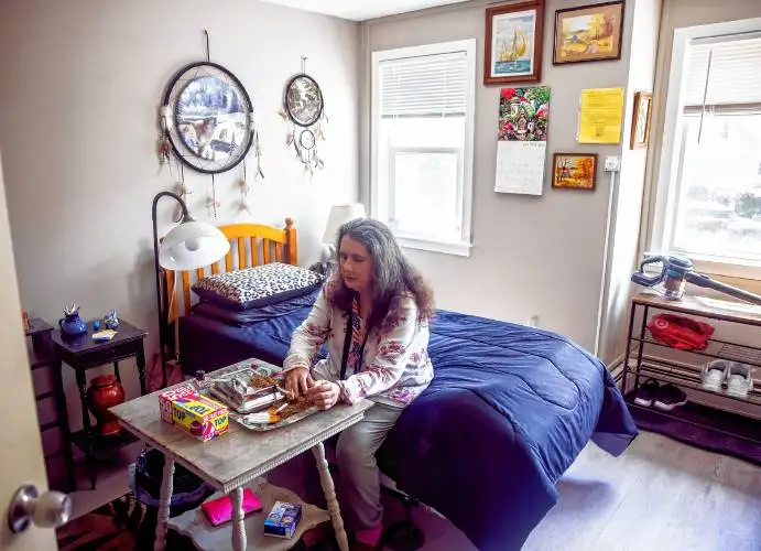 Denise DeLew keeps her room clean and orderly at the Fellowship Housing apartments in downtown Concord on Wednesday. DeLew rolls her own cigarettes that she smokes outside the facility.