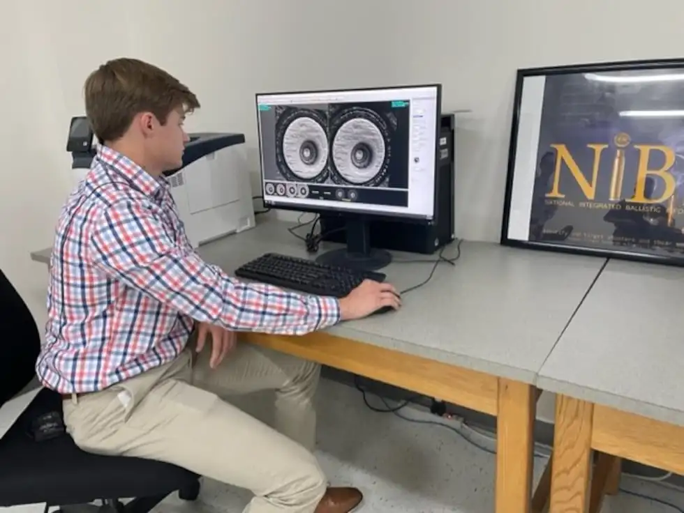 A forensic laboratory technician demonstrates how NIBIN technology works at Ohio BCI's...