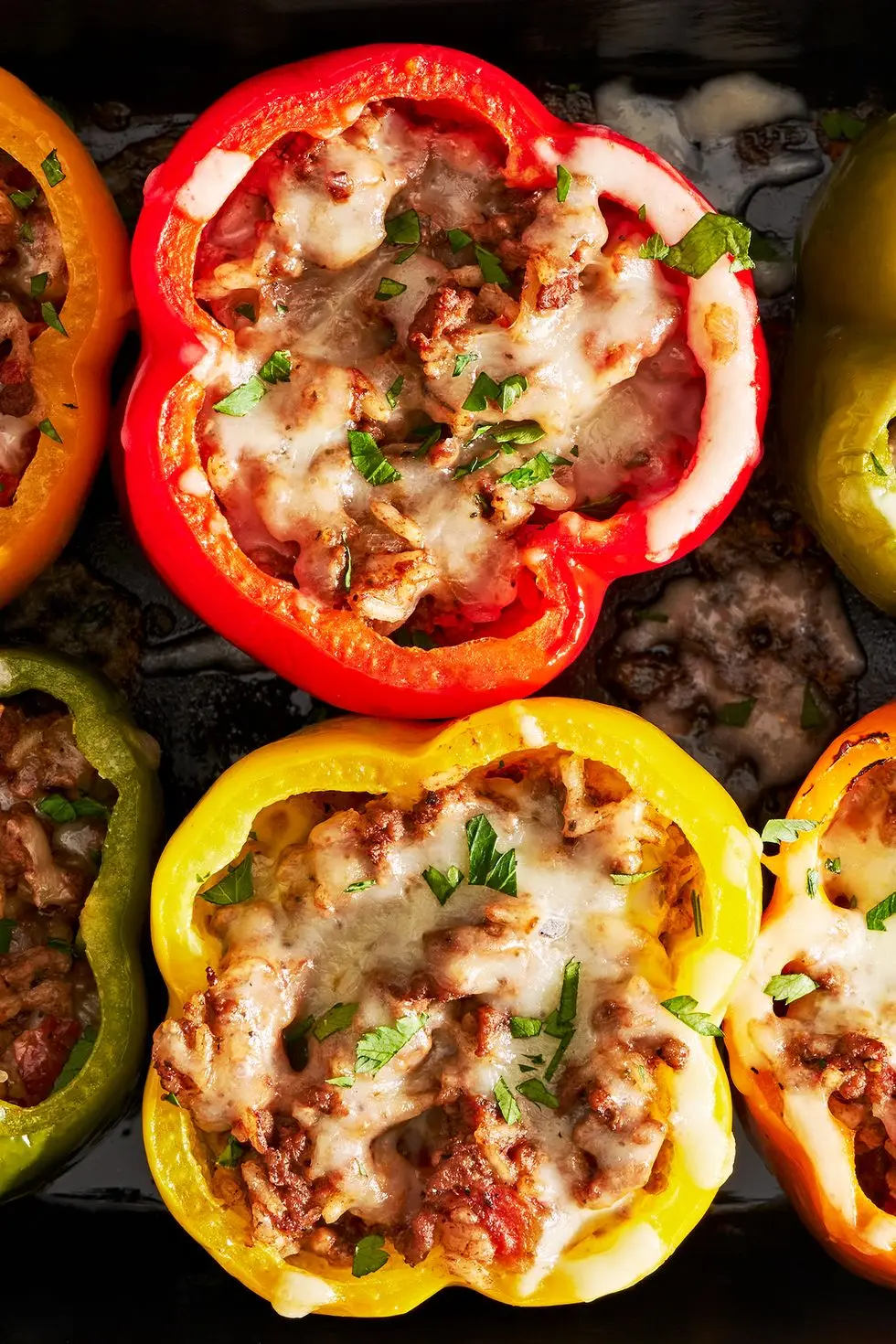 colorful stuffed peppers with ground beef and tomato rice