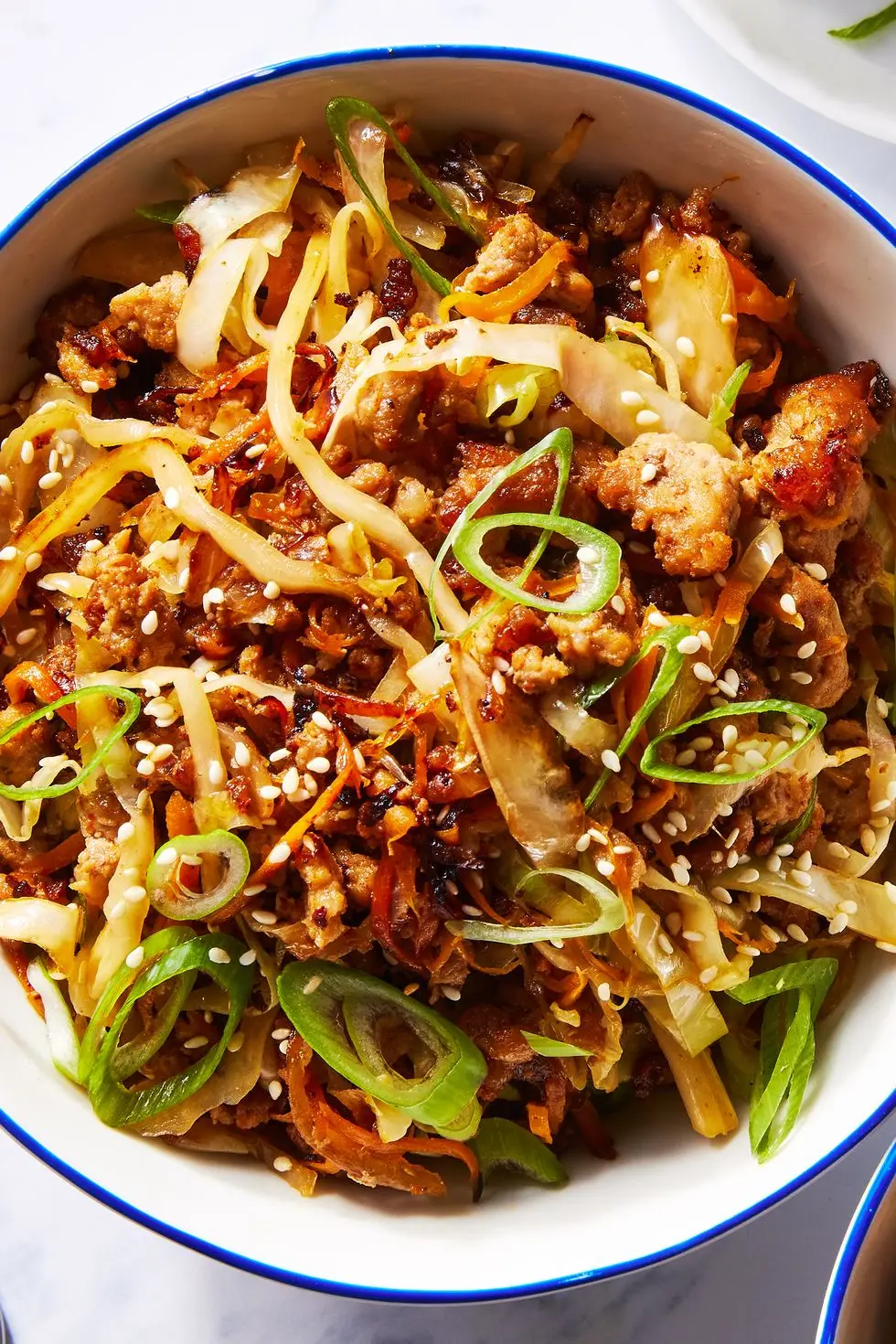 ground pork, cabbage and carrot in a bowl