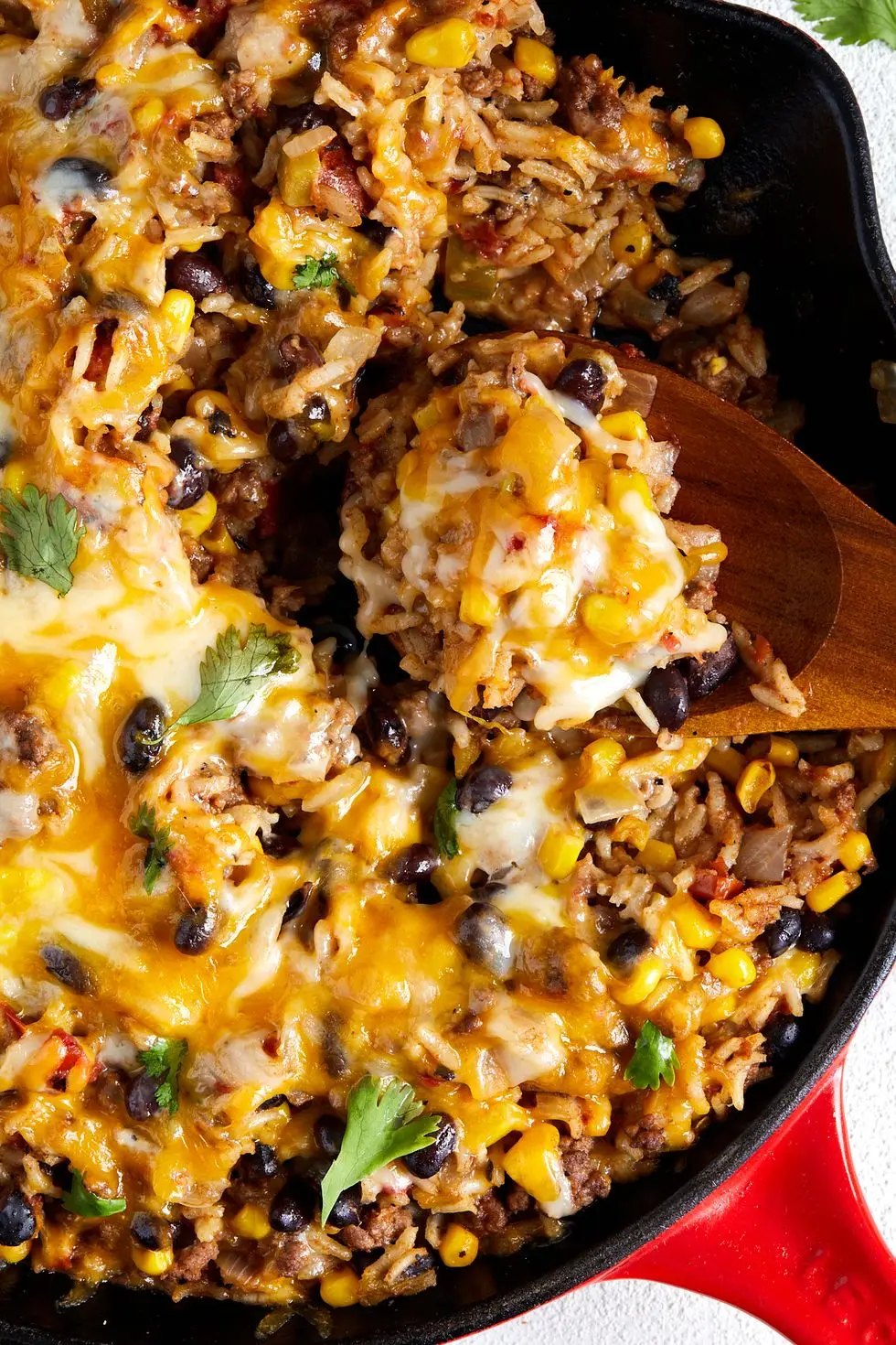 mexican beef 'n rice skillet topped with melty cheese and cilantro