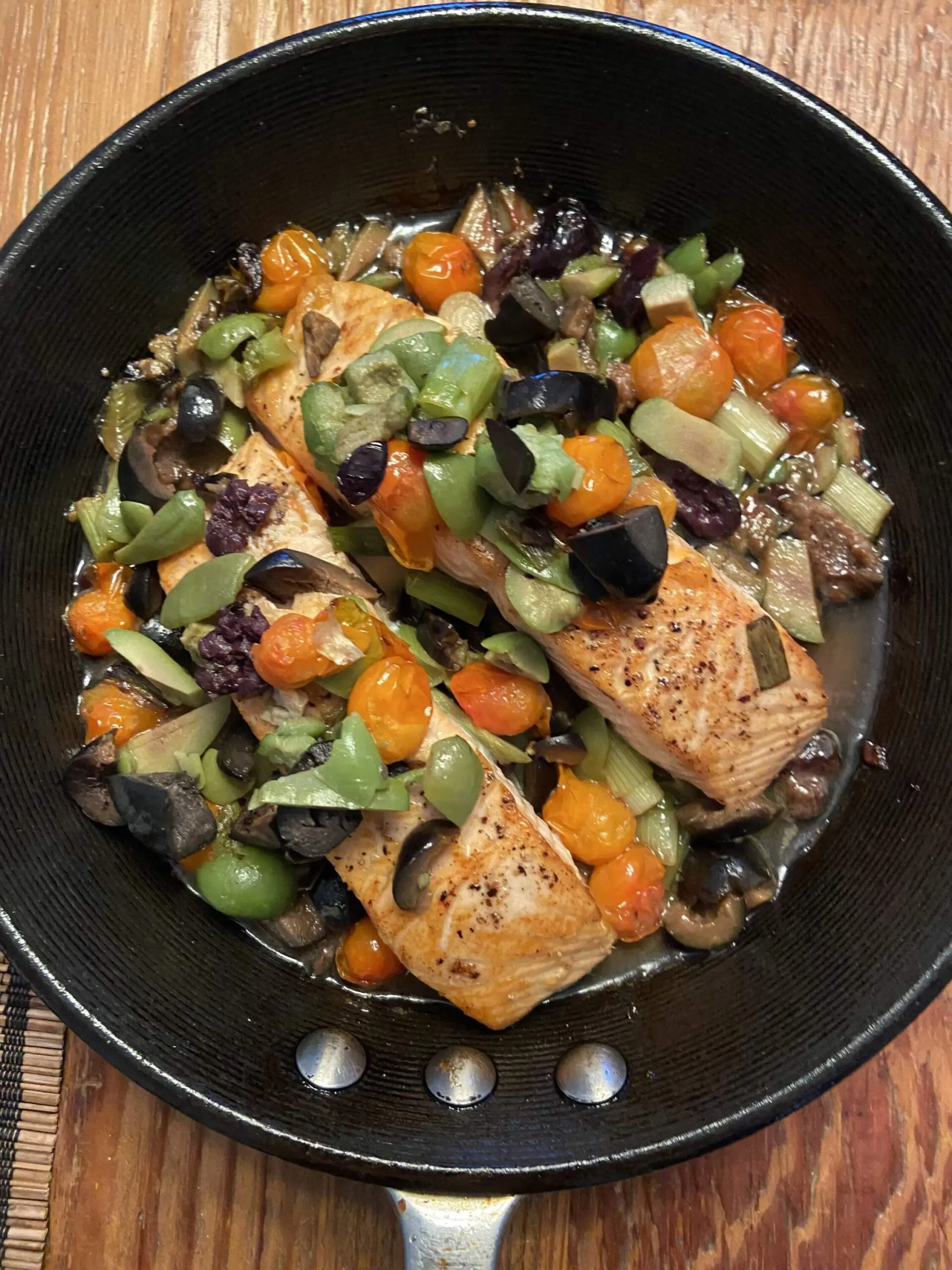 Roasted salmon with three olive, scallion and cherry tomato topping. (Kathy Gunst/Here & Now)