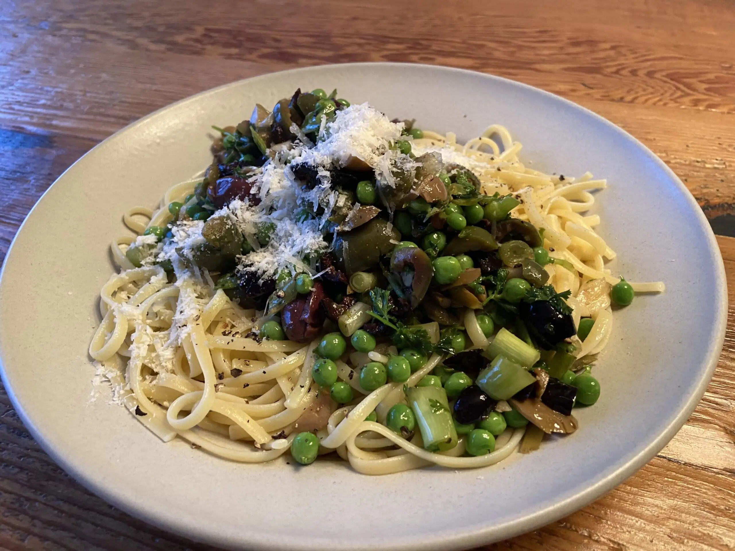 Linguine with mixed olives, spring peas and parsley. (Kathy Gunst/Here & Now)