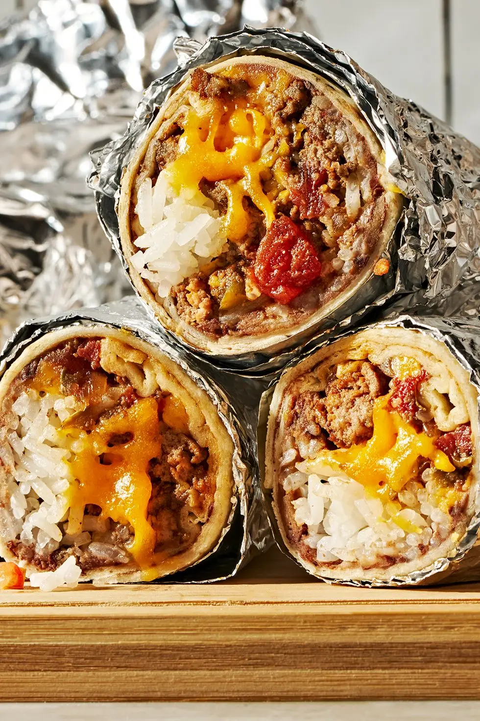 seasoned ground beef layered with refried beans, rice, and a blend of monterey jack and cheddar cheese then rolled into a flour tortilla