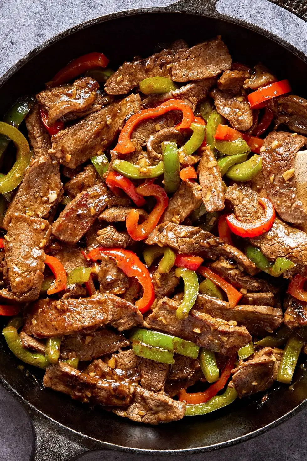 steak with sliced red and green peppers