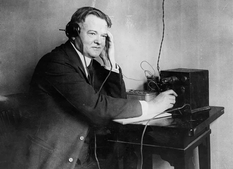 U.S. President Herbert Hoover listening to a one valve radio set in 1928.