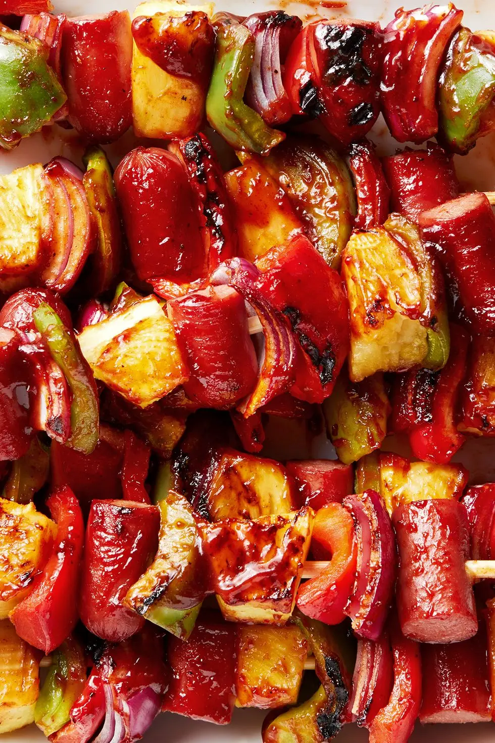 grilled skewers with sliced hot dogs, pineapple, red bell peppers basted with a bbq sauce