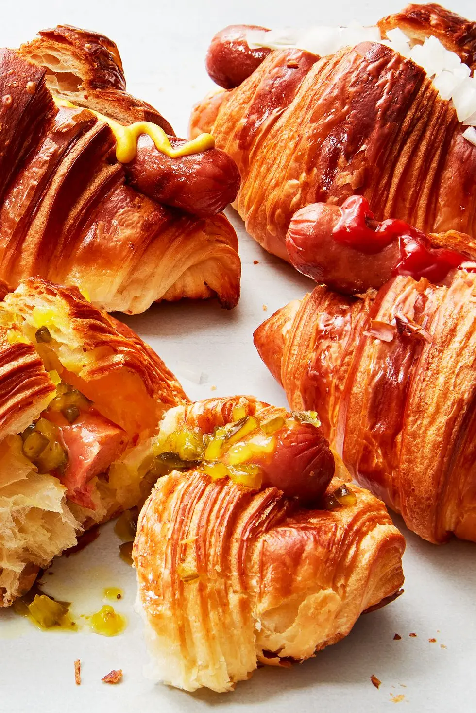 hot dogs in croissants with toppings