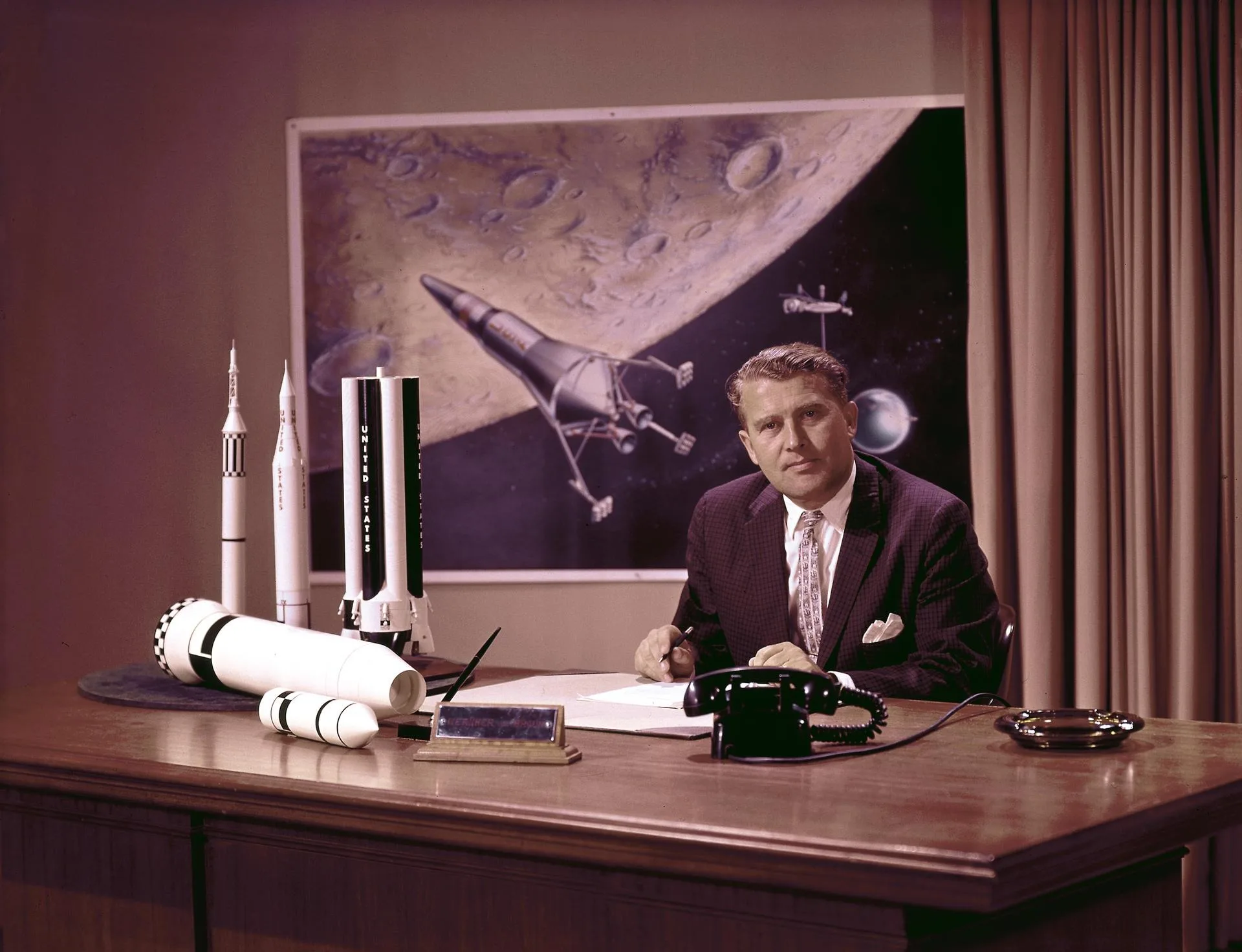 Wernher von Braun poses at his desk at the Marshall Space Flight Center (MSFC). Credit: NASA.