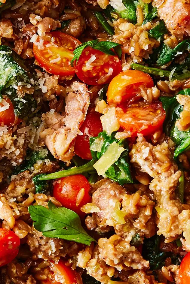 one pot farro with chicken sausage and tomatoes topped with fresh herbs