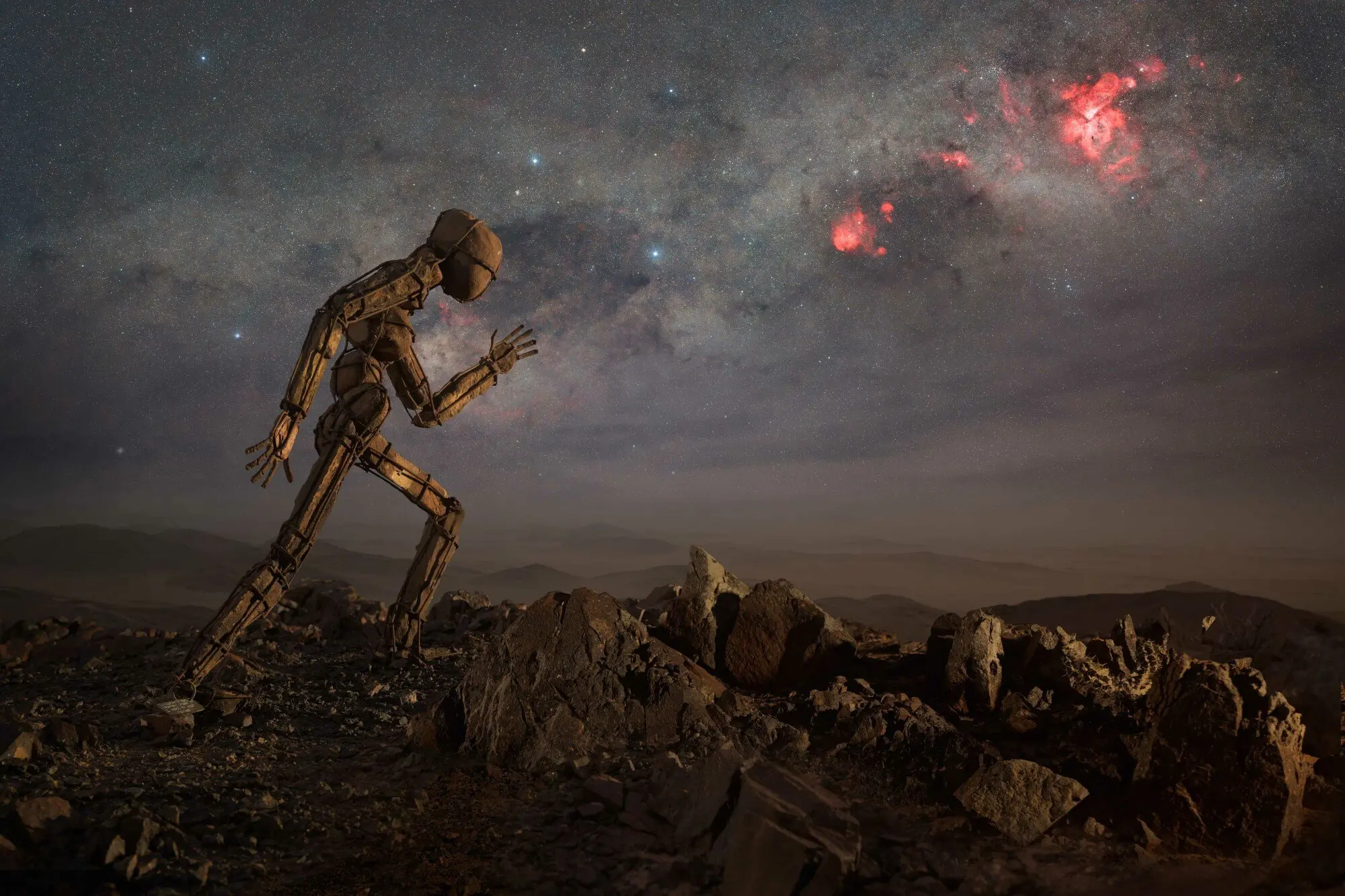 The Carina arm of the Milky Way with a statue in the front, photographed in Kunene Region, Namibia.