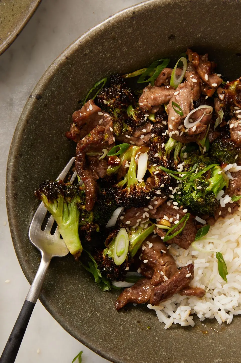 air fryer beef and broccoli in a bowl with white rice