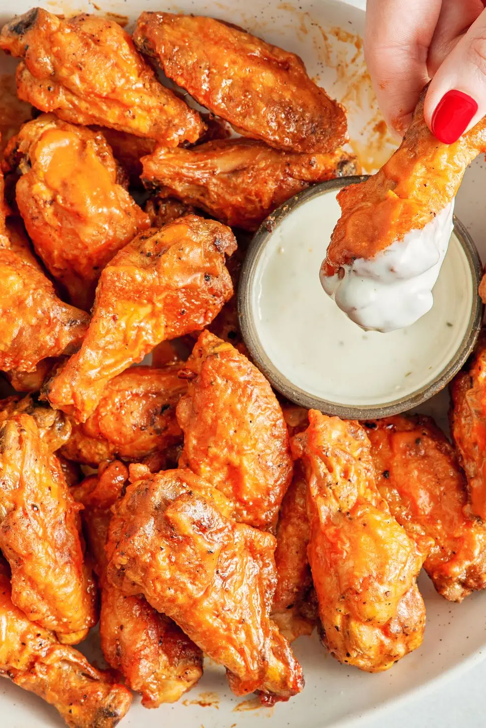 Air Fryer Chicken Wings air fryer chicken wings covered in buffalo sauce with blue cheese and celery