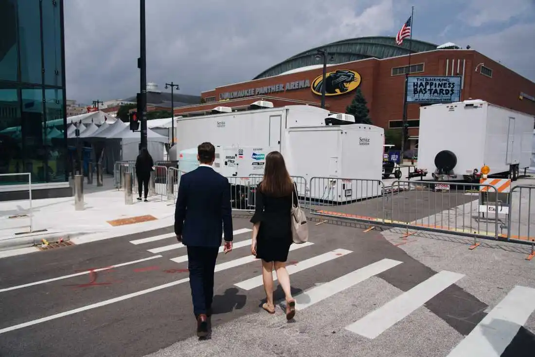 Stephen Perkins and Karly Matthews walk towards Baird Center were American Conservation Coalition is hosting a booth at the Republican National Convention in Milwaukee, Wisconsin. Grace Widyatmadja/NPR