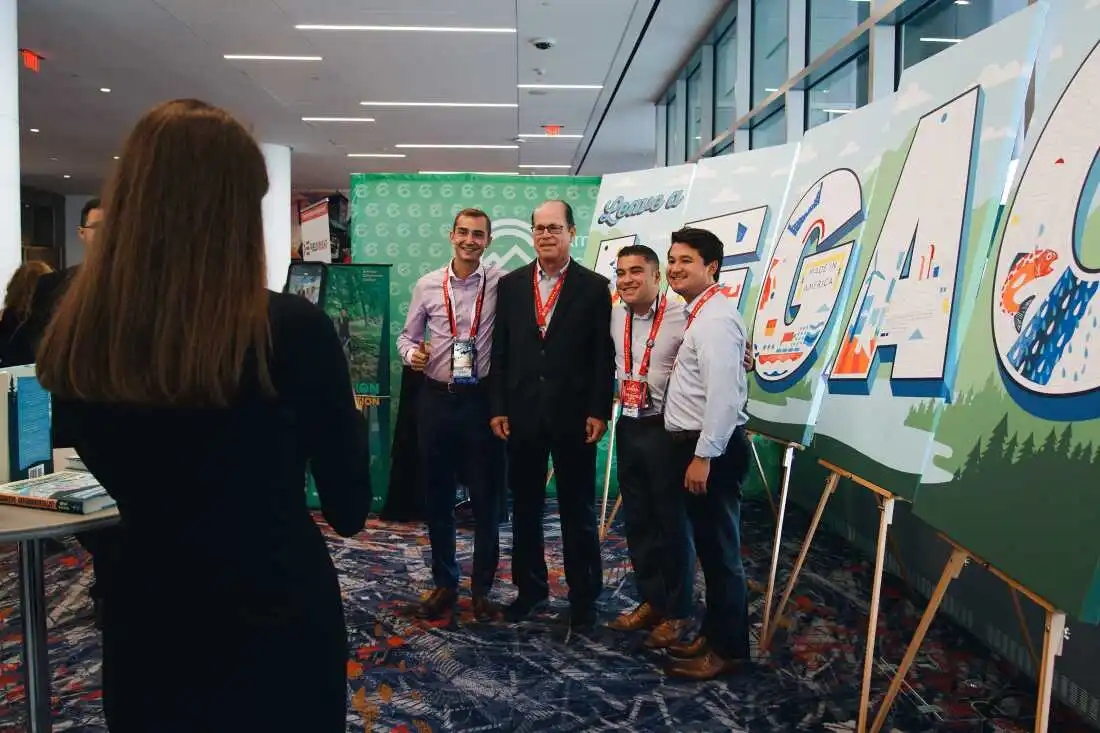 Aidan Shank, Brian Martinez and Michael Esposito take a photo with Republican Senator of Indiana, Mike Braun, at ACC's booth in Baird Center during the second day of the Republican National Convention.