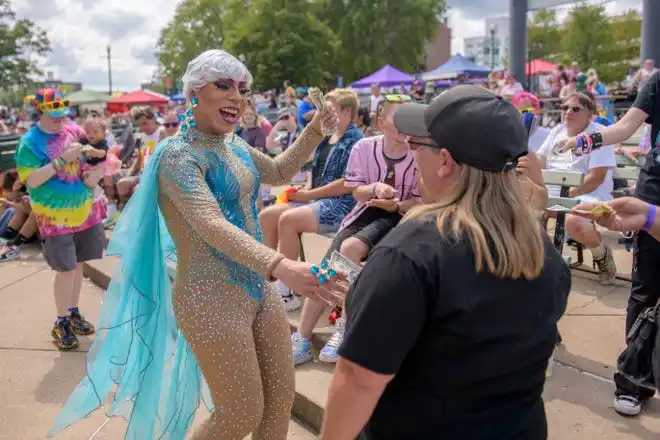 Drag performer DeCevia Mann accepts a tip from a fan during the Drag Show Wars at the River City Pride Festival on Saturday, July 20, 2024 on the Peoria riverfront.