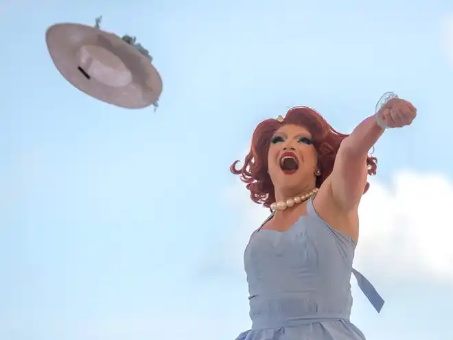 Drag queen Portia Lynn Snaps tosses her hat into the crowd for the finale of her second performance during the River City Pride Festival on Saturday, July 20, 2024 on the Peoria riverfront.