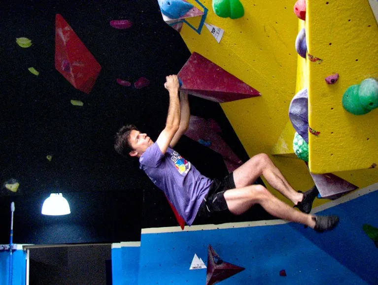 Krzysztof Gaidzik climbing an indoor climbing wall