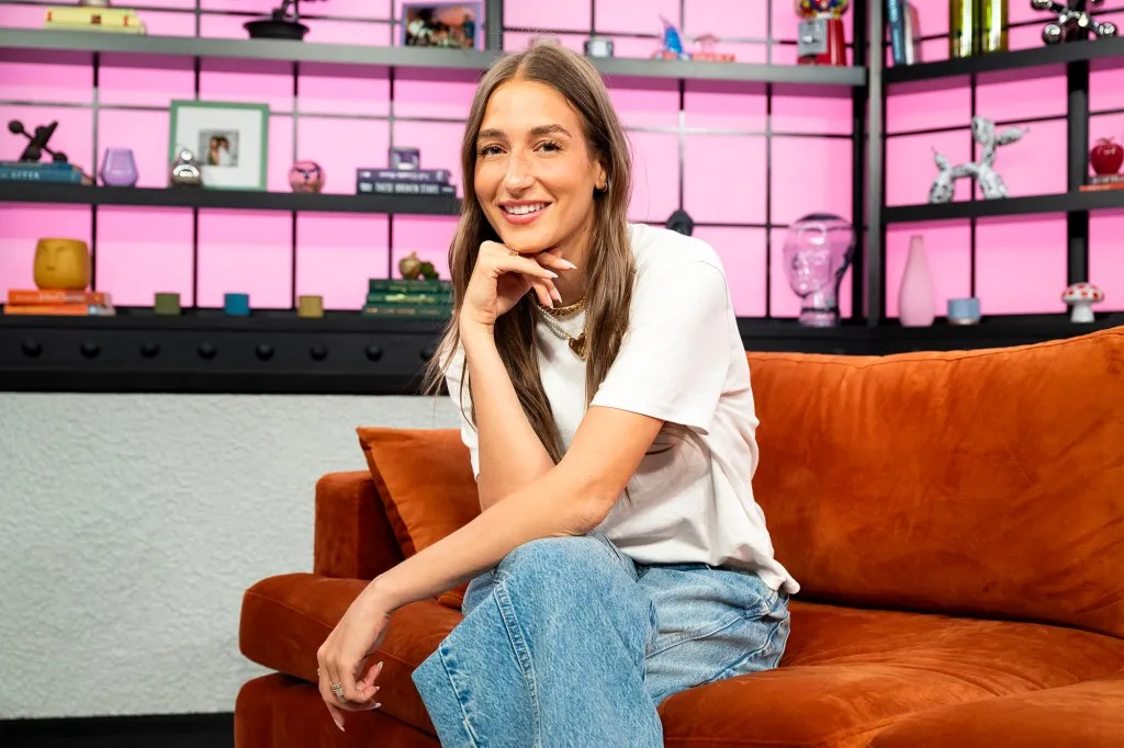 Amanda Batula sitting on couch