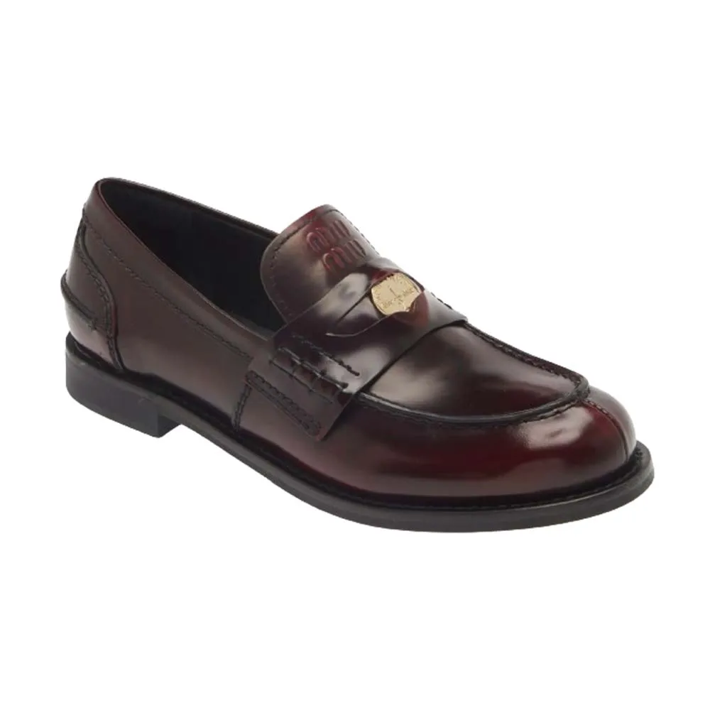 brown leather loafers with gold charm