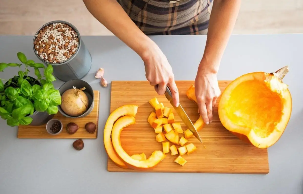 Person cuts up a pumpkin